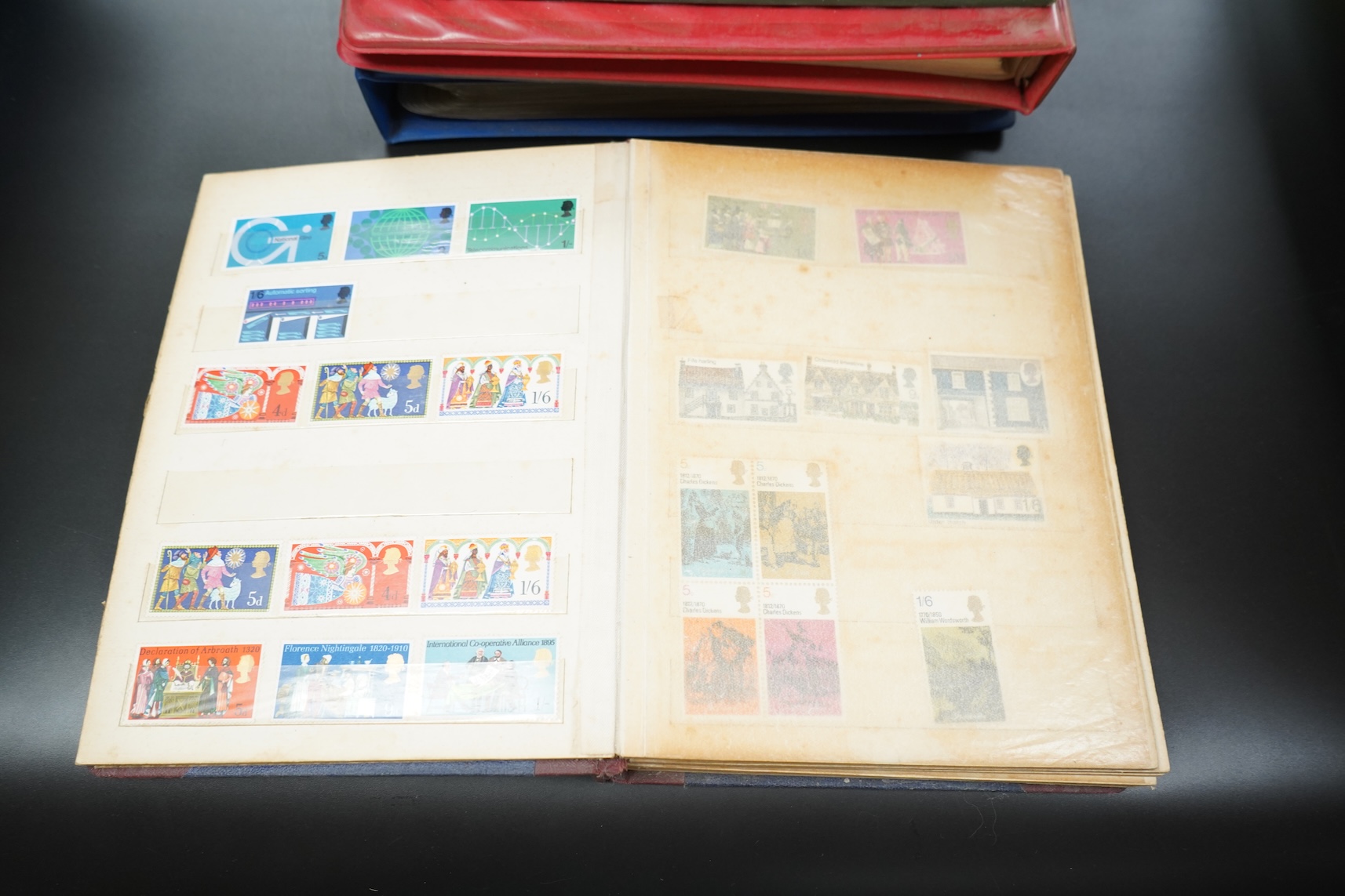 Four stamp albums including a first day cover album